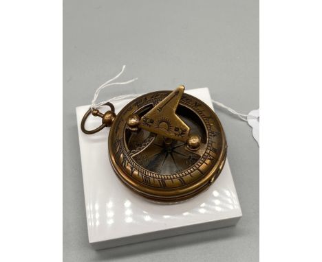 A Brass cased compass and sundial. 