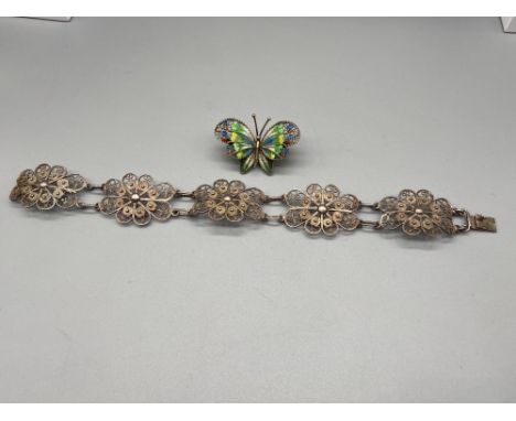 A Silver Filigree flower design bracelet. Together with an 800 grade and enamel butterfly brooch. 