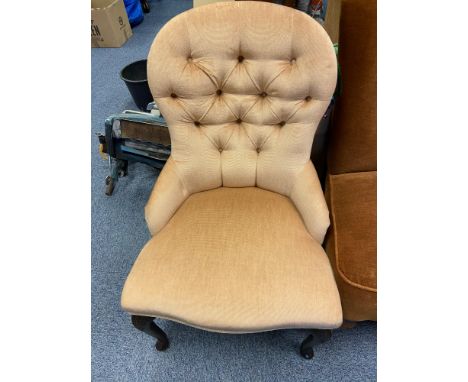 A Vintage button back bedroom chair designed with queen anne legs. 