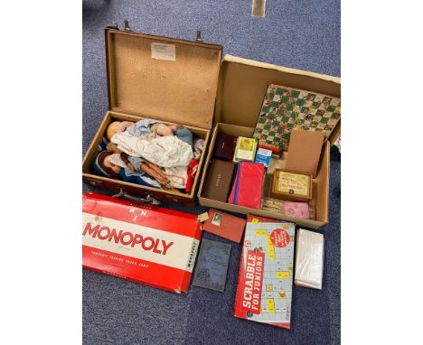 A Lot of vintage board games, accessories and travel case containing vintage dolls and mickey mouse hand puppet. 