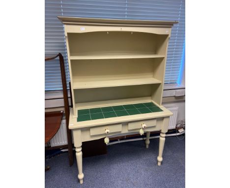 A Contemporary pedestal leg, kitchen dresser. Designed with tile top surface and two under drawers. 