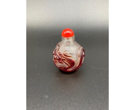 A vintage Chinese hand carved perfume bottle designed with a dragon. [Two small hairlines to the rim] 