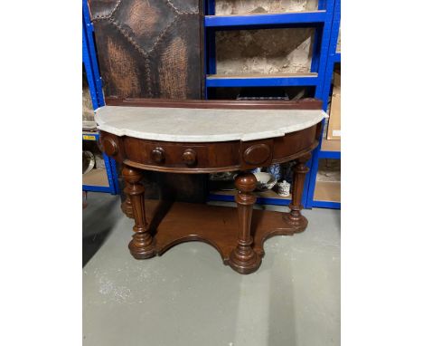 A Victorian Mahogany and Marble top half moon console table. 