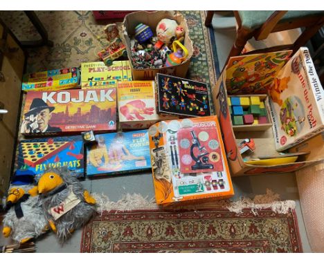 Two boxes containing a collection of vintage board games, microscope, Plush Wombles and loose Britains soldiers 