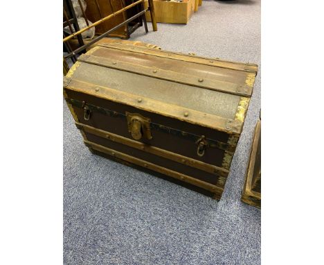 Antique Saratoga trunk designed with wood and metal bounds. 