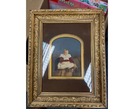 A 19th century portrait of a child seated. Fitted within a gilt moulded frame. 