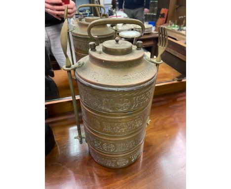 An Antique Indian Brass four section food carrier with fork and spoon utensils. Engraved with various writing, flowers and sh