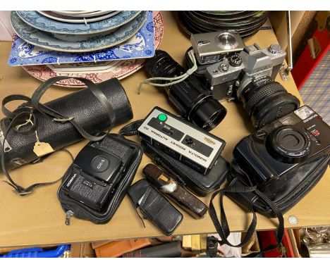 A Selection of vintage Cameras and lenses to include Minolta SRT101, Cosina CX-1 Camera and Soligor zoom lens 