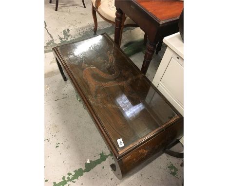 A Singapore style, glass topped table.