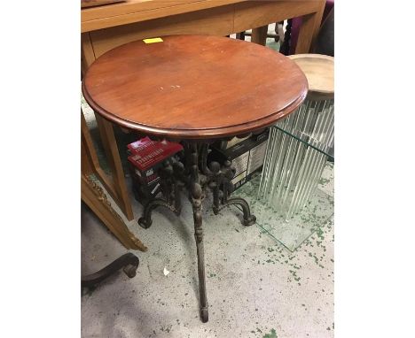 A cast iron legged oak topped table