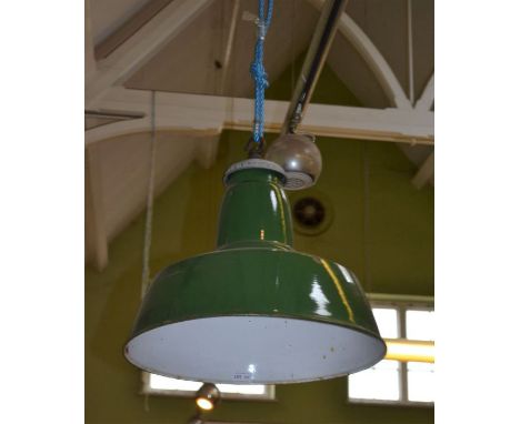 A pair of green and white enamel industrial light shades