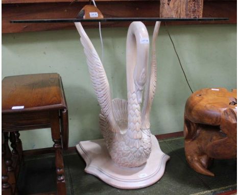 A glass topped console table on life-sized carved wooden swan base, 76cm high, 56cm deep, 110cm wide&nbsp;