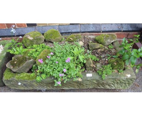 An outdoor garden stone trough, previously an indoor sink