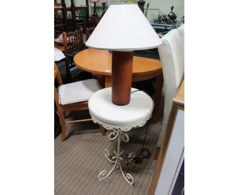 A painted metal circular topped table with a leather covered table lamp with shade