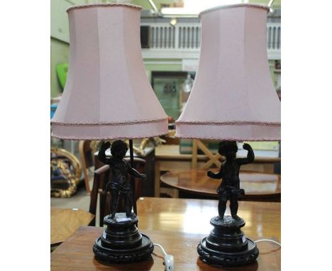 A pair of probable French cast spelter Putti figures on turned wooden plinths 29 cm high. On associated Oriental design lamp 