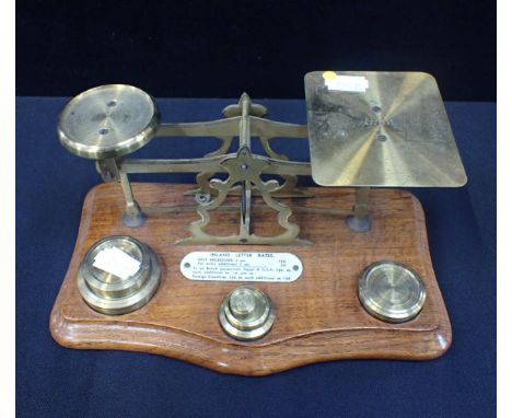A POSTAL SCALE WITH BRASS WEIGHTS and ivorine Rates plaque