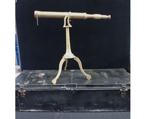 A DECORATIVE BRASS TELESCOPE ON TRIPOD STAND and a Gieves military Japanned tin trunk 107cm long (2)