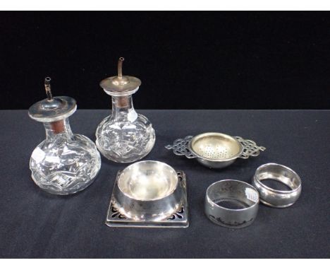 PAIR OF SILVER TOPPED GLASS CONDIMENT BOTTLES with a silver napkin ring and other plated items