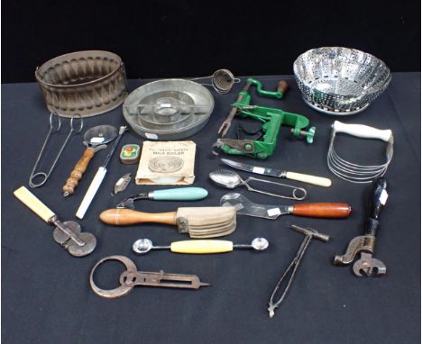 A MECHANICAL APPLE PEELER, A 'DAVIS' MILK BOILER an A.S.Co Columbia patent tin opener, a tin pie mould, and other kitchenalia