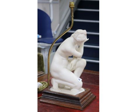 A carved alabaster model of Venus crouching, fitted as a table lamp (restored)