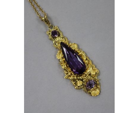 A repousse yellow metal and amethyst set tapering pendant, on a yellow metal chain, pendant 63mm.