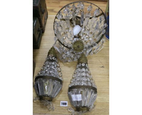 A brass and glass drop ceiling light and a matching pair of wall lights
