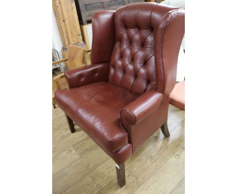 A button back leather wing armchair