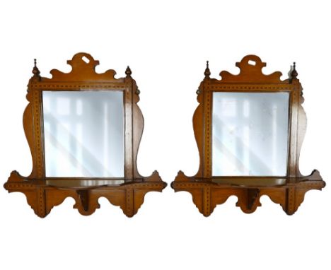 Pair of inlaid Edwardian hall mirrors with shelf, height 55cm, width 55cm, one with damaged finial. 