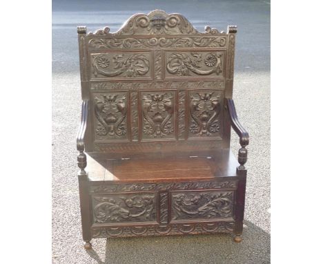 Victorian carved dark Oak hall bench with lift up lid, carved with dragons, w.100 x d.53 xh.139cm. 