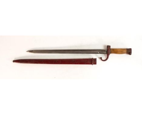 A WWII Japanese style bayonet with scabbard. Painted red with wooden grips. Length incl. scabbard: 52.6cm 