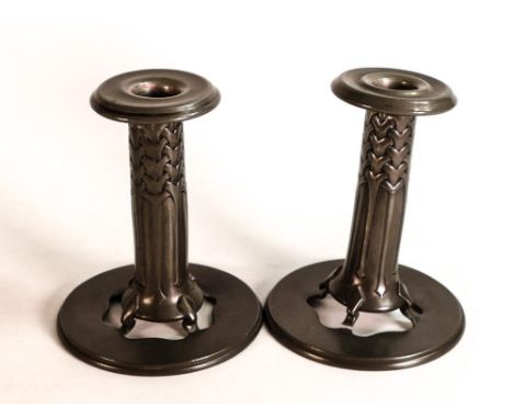 A pair of Pewter candlesticks with a pierced stand, and loose sconce made by Liberty &amp; Co. Height 12.5cm, slight damage b
