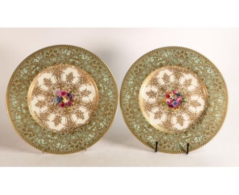 Royal Worcester hand painted cabinet plates. Painted with floral sprays by E. Phillips. Borders decorated with raised gilt Ar