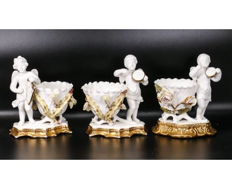 Two late 19th century James Shaw (one item unmarked) &amp; similar later porcelain Putti form vases, encrusted with flowering