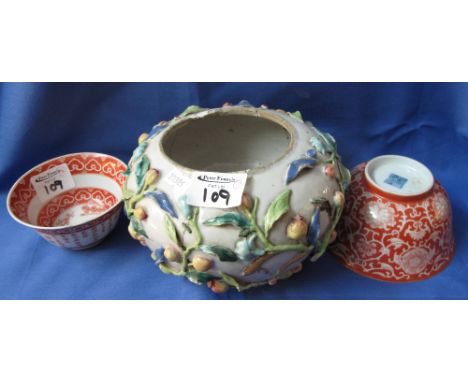 Three assorted Chinese porcelain bowls, one applied all over with relief floral decoration, the other two with red ground, fo