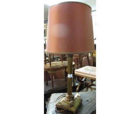 Modern brass table lamp with shade.