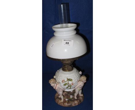 Sitzendorf continental German porcelain cherub mounted oil lamp with light glass shade and clear chimney. CONDITION REPORT: G