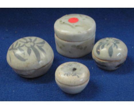 Four Chinese porcelain cushion shaped lidded boxes decorated in underglaze blue or degraded overglazed green.  Varying sizes.