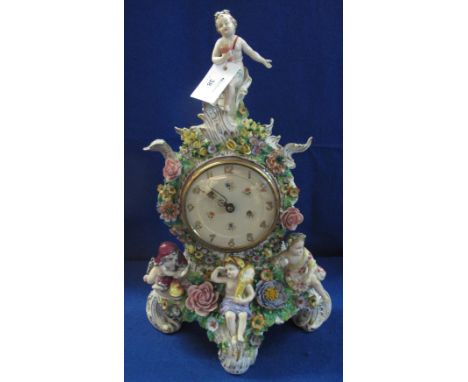 Early 20th Century continental porcelain cherub mounted, floral decorated balloon shaped mantle clock.   CONDITION REPORT: Da