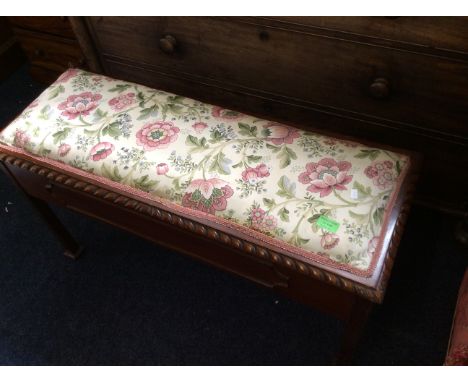 A mahogany framed duet piano seat, with floral cushion cover.