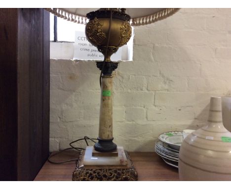 A brass and onyx central column table lamp.