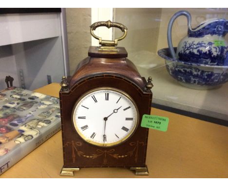 An oak cased mantle clock with inlay decoration.