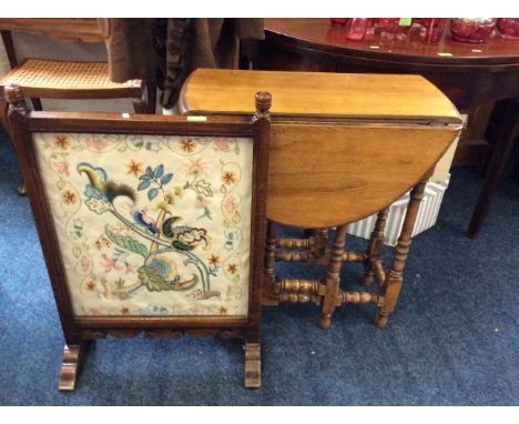 An oak framed embroidered fire screen together with an oak gate lag table and a singer sewing machine.