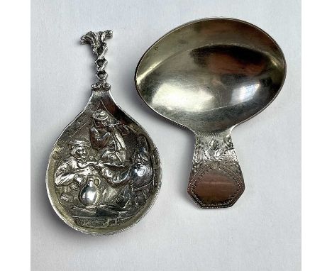 A George III silver caddy spoon, London 1800, together with a Dutch silver caddy spoon, the bowl cast with three figures in a