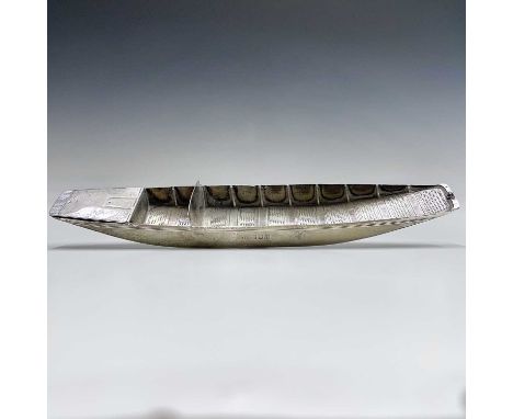 An Edwardian silver novelty desk stand in the form of a punt by Harrison Brothers &amp; Howson, with hinge lidded compartment