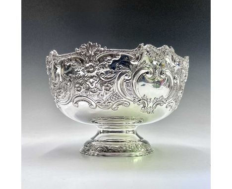 An impressive Victorian silver embossed pedestal punch bowl by Goldsmiths Company, the gadrooned and leaf cast rim over the f
