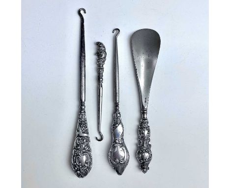 Four dressing table implements with silver filled handles, one a button hook with 'Punch' handle.