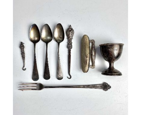 Miscelleneous silver including an egg cup, set of three George III Old English pattern teaspoons, an Edwardian pickle fork, t