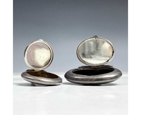 A George V silver oval compact fob with mirrored hinged lid, Chester 1920, width 48mm, together with another silver compact f