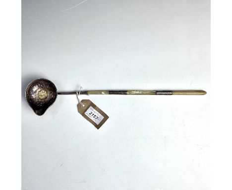 An 18th century silver punch ladle, the foliate embossed bowl set with a Queen Anne gilded sixpence, with mother of pearl sil