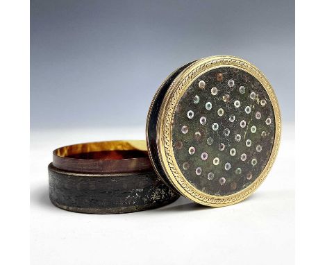 A 18th century French gold mounted mother of pearl dot inlaid circular section snuff box, diameter 62mm, height 29mm.